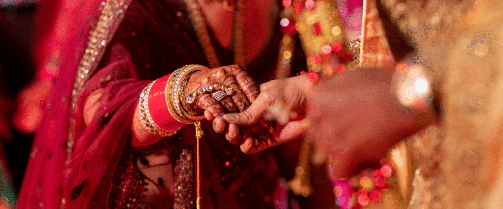 Hands adorned with jewelry and henna